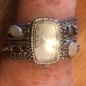 Bracelet watch with mother of pearl and chains.